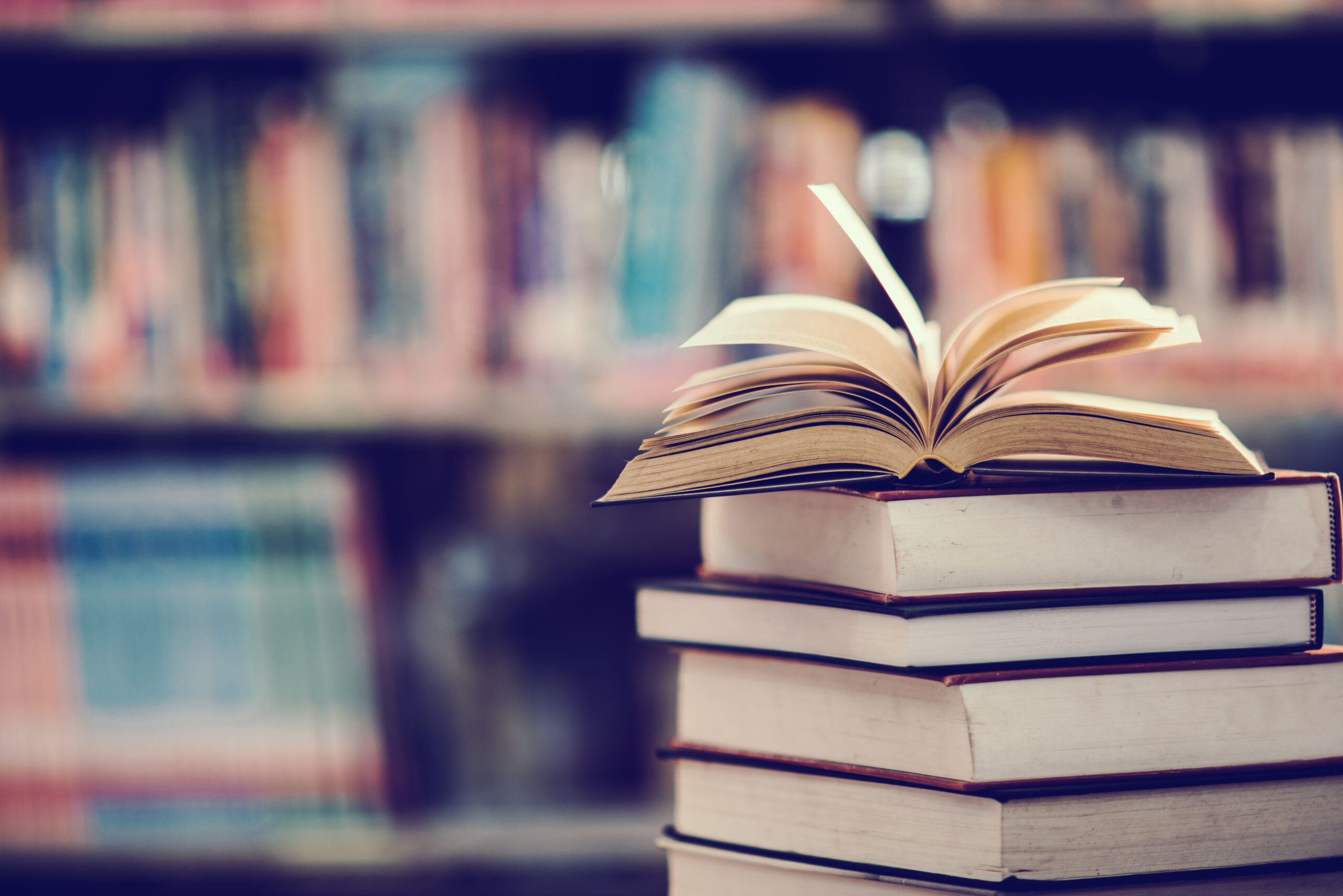 book-in-library-with-open-textbook-scaled.jpg book-in-library-with-open-textbook-scaled.jpg